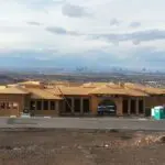 A large building with a car parked in front of it.