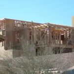 A building under construction with some trees in the background.