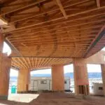 A view of the inside of a building with wooden beams.