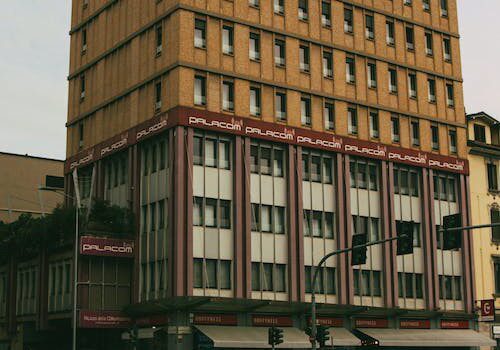 A tall building with many windows on the top of it.